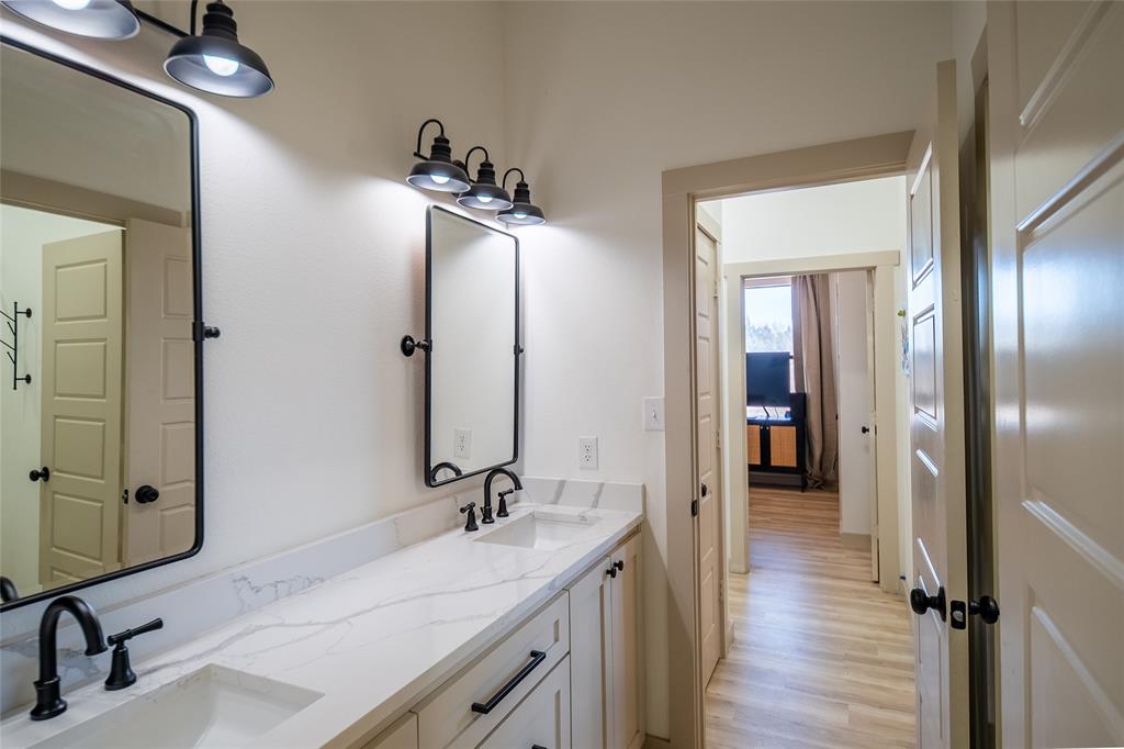 375 Wolf Front Road Van Alstyne, TX 75495 - Photo 28 of 40 a bathroom with a sink and mirror