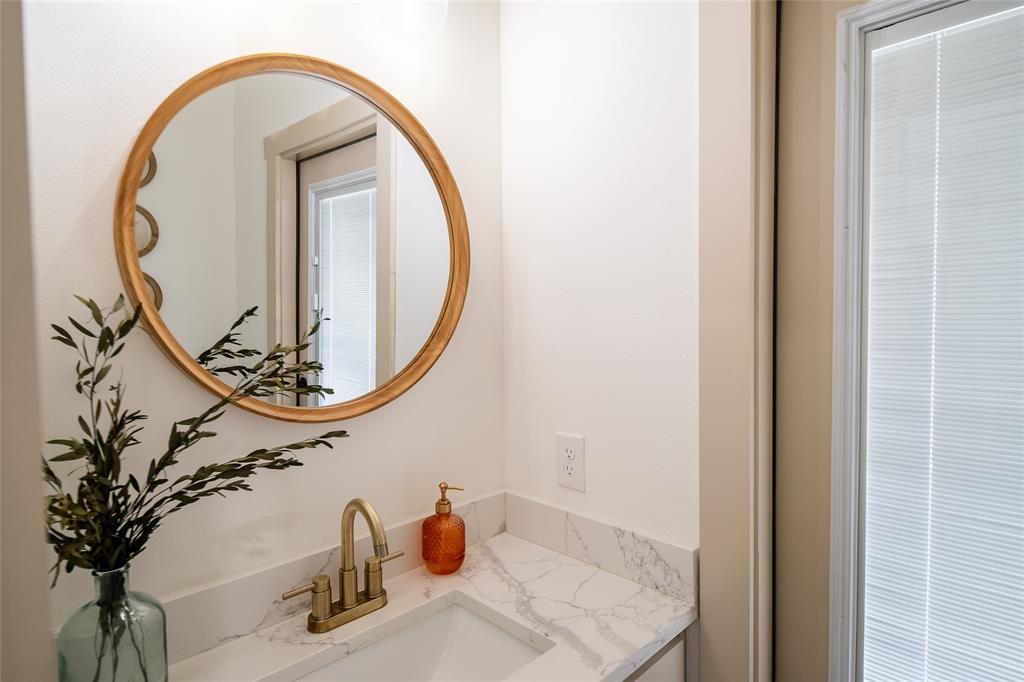 375 Wolf Front Road Van Alstyne, TX 75495 - Photo 29 of 40 a bathroom with a sink and a mirror