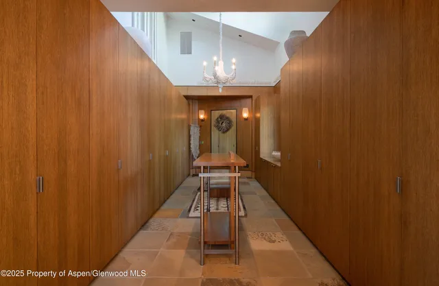 a view of a chair and table in the patio next to a yard