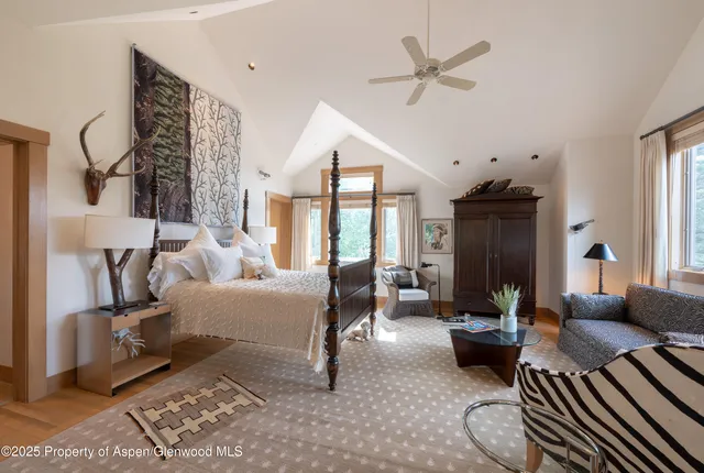 a bathroom with a granite countertop sink a mirror and a shower