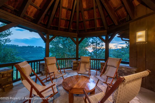 a view of a chairs and table in patio with a yard
