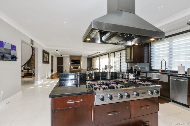 a kitchen with stainless steel appliances granite countertop a stove and a sink