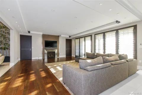 a living room with furniture fireplace and flat screen tv