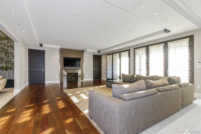 a living room with furniture fireplace and flat screen tv
