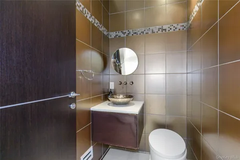 a bathroom with a sink a toilet and a mirror