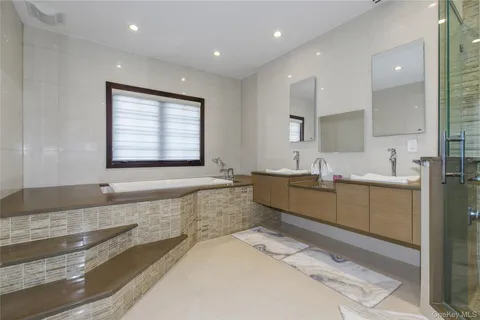a large bathroom with a large tub and sink