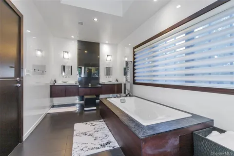 a bathroom with a sink a mirror and a bathtub