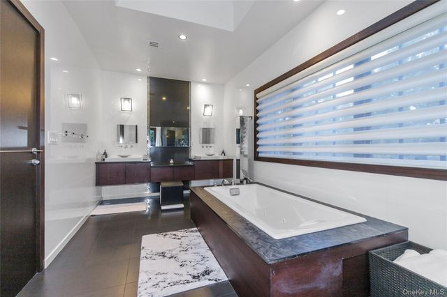 a bathroom with a sink a mirror and a bathtub