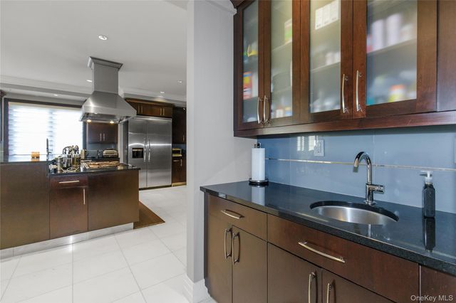 a kitchen with stainless steel appliances granite countertop a sink and cabinets