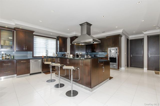 a kitchen with stainless steel appliances kitchen island granite countertop a sink and cabinets