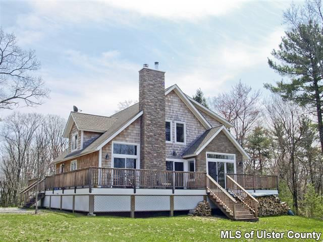 39 Sun Mountain Road Stone Ridge, NY 12484 - Photo 1 of 1 a view of a house with a big yard and large trees