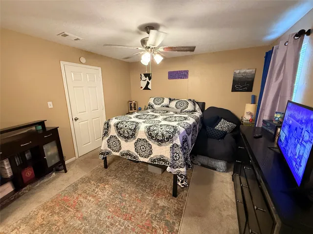 a bedroom with bed and a mirror