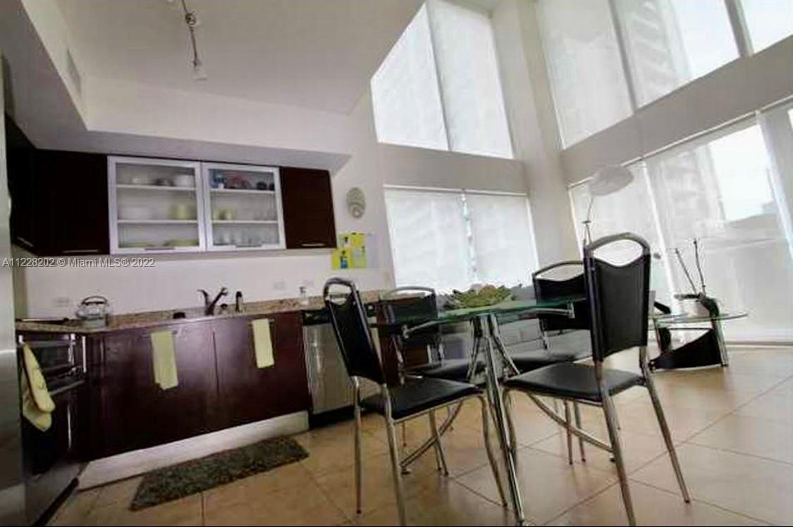 41 Southeast 5th Street, Unit 702 Miami, FL 33131 - Photo 12 of 23 a view of a dining room with furniture