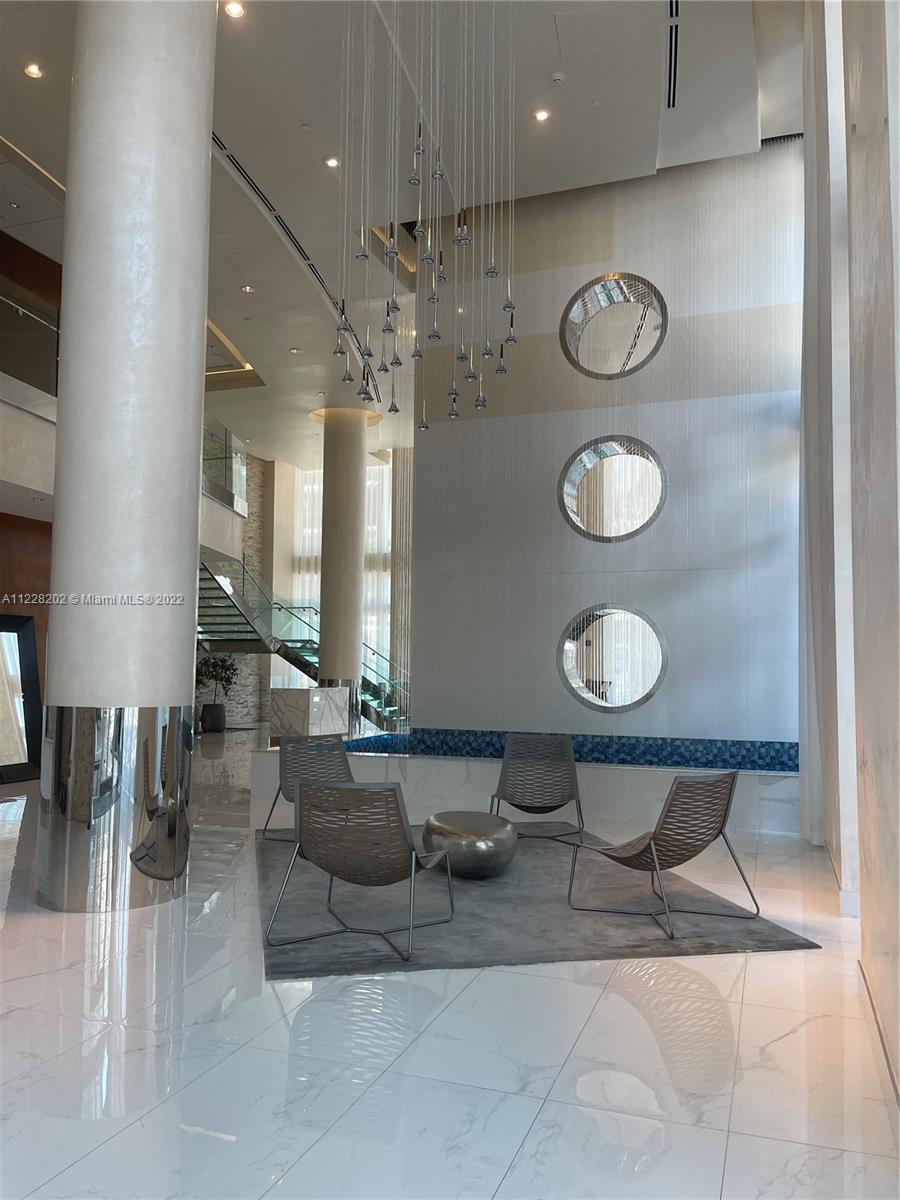 41 Southeast 5th Street, Unit 702 Miami, FL 33131 - Photo 5 of 23 a view of a lobby with furniture and rug