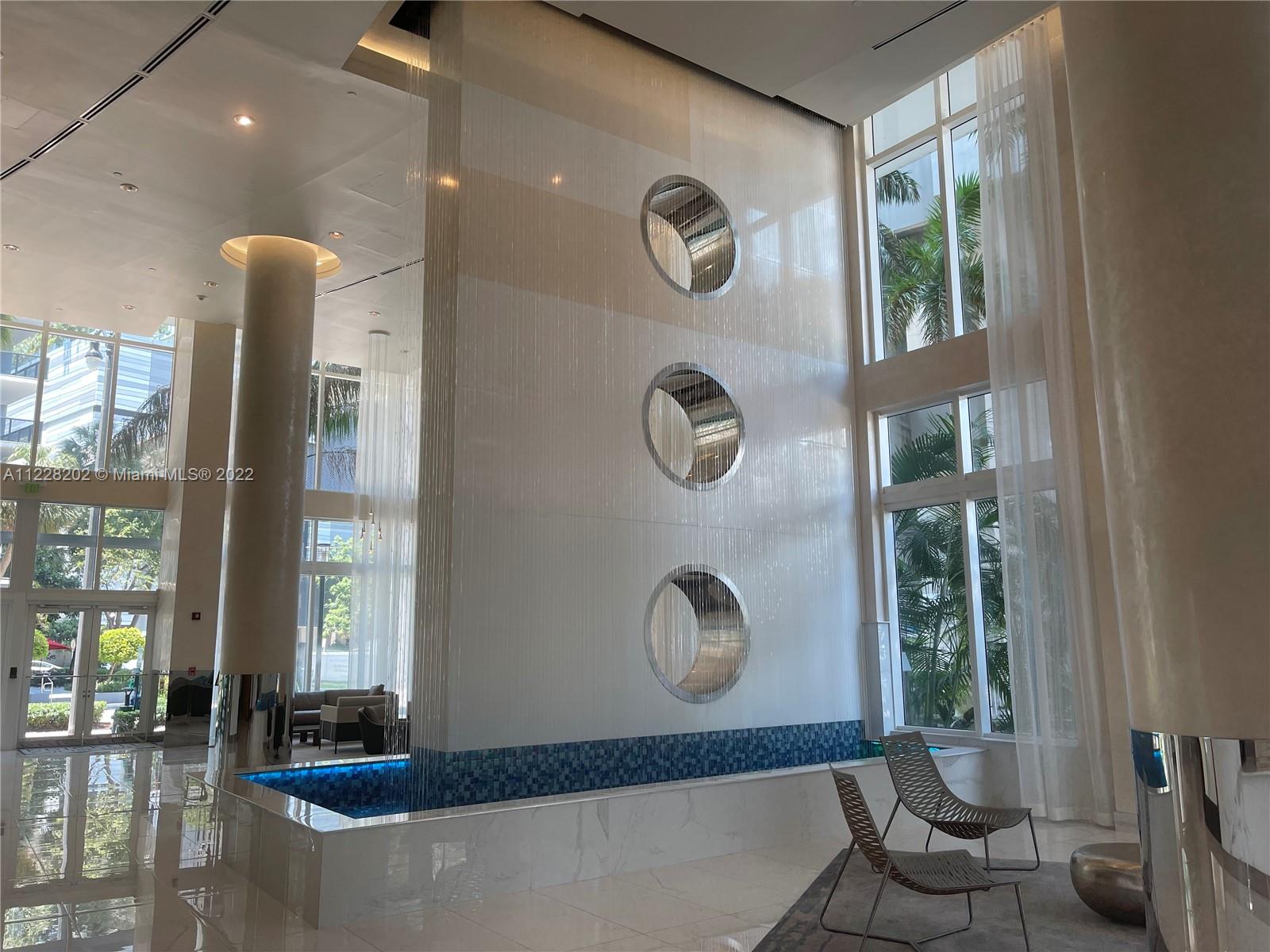 41 Southeast 5th Street, Unit 702 Miami, FL 33131 - Photo 6 of 23 a front view of a house with a garden