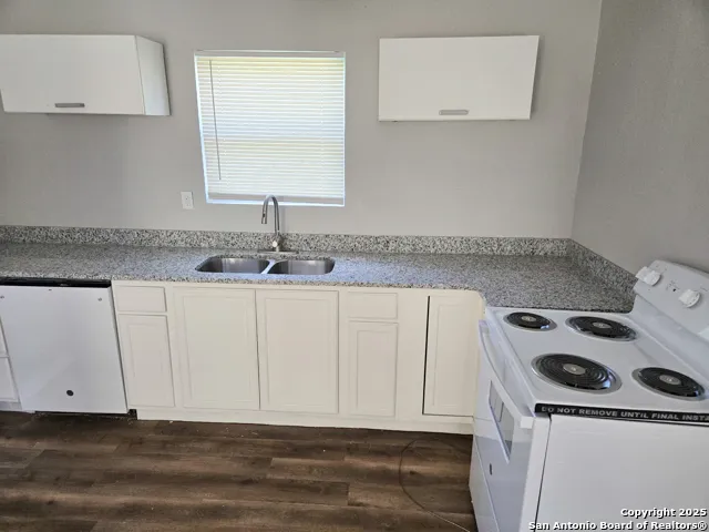 a kitchen with a sink and cabinets