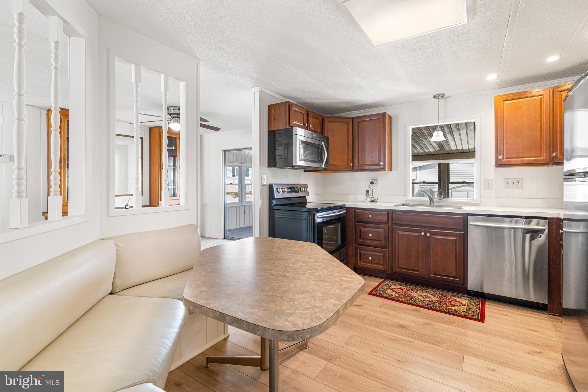 254 Rabbit Run North Wales, PA 19454 - Photo 9 of 22 a kitchen with stainless steel appliances granite countertop a stove a sink a refrigerator dining table and chairs