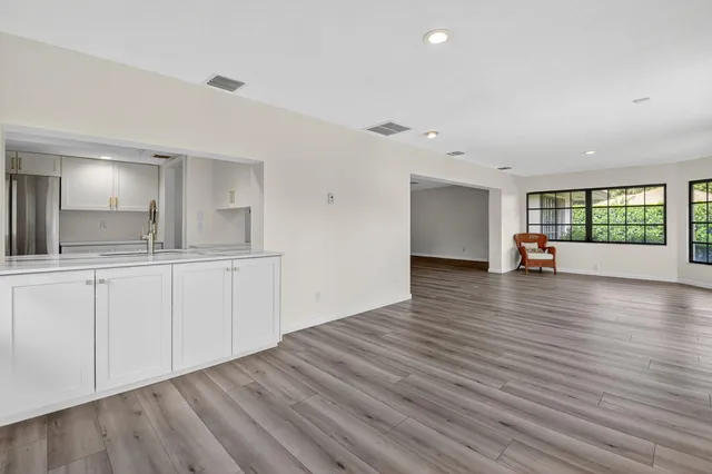 a view of a kitchen counter space and wooden floor