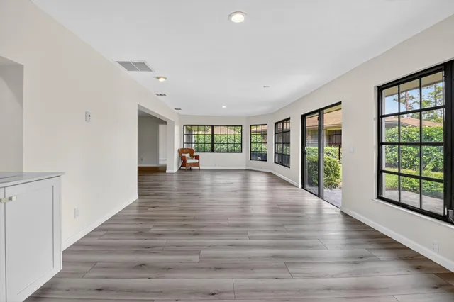 a view of an entryway with wooden floor and windows