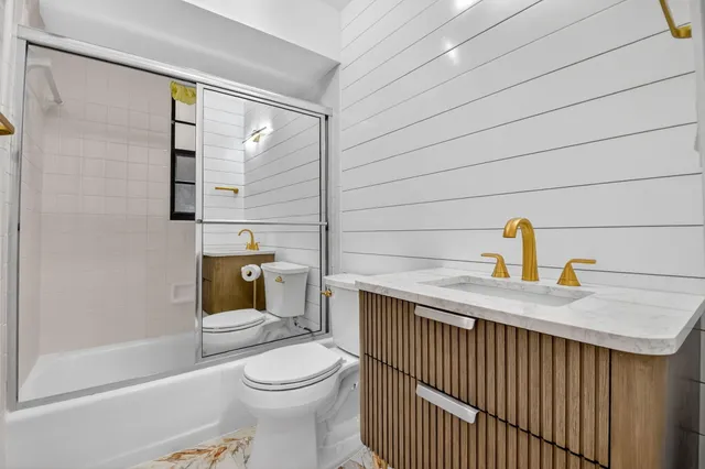 a bathroom with a toilet a sink and bathtub