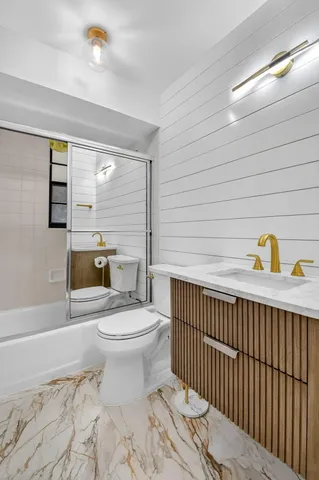 a view of a room with wooden floor chandelier and windows