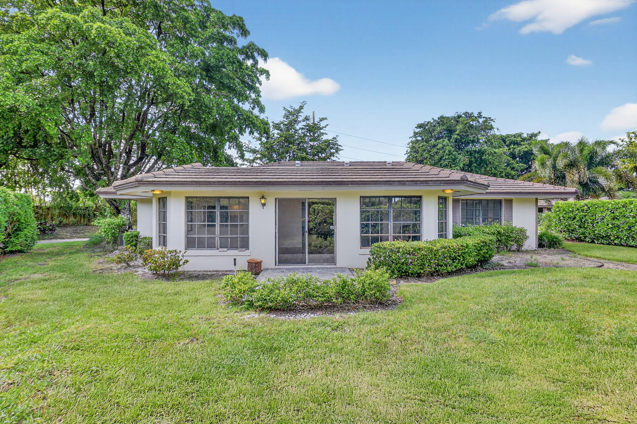 600 Cypress Key Drive Atlantis, FL 33462 - Photo 41 of 43 a front view of a house with a yard and porch