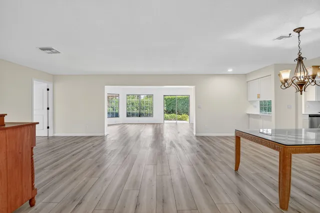 a view of a livingroom with wooden floor and furniture