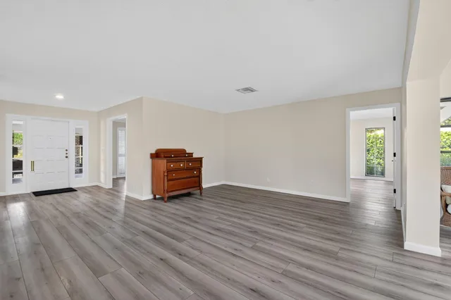 a view of an empty room with wooden floor
