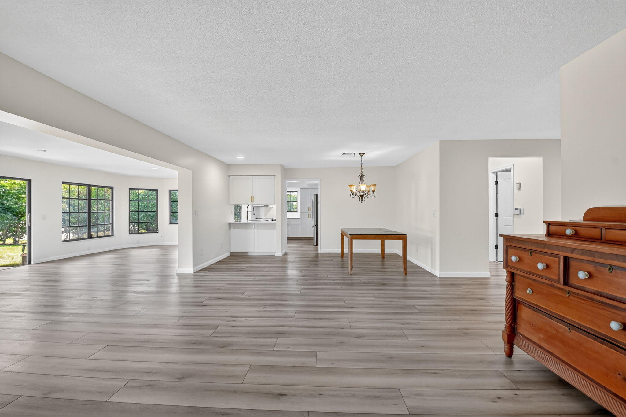 600 Cypress Key Drive Atlantis, FL 33462 - Photo 10 of 43 a view of an empty room with wooden floor and a window