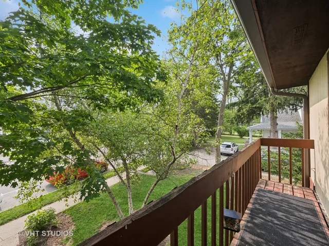 a view of a wooden deck next to a yard