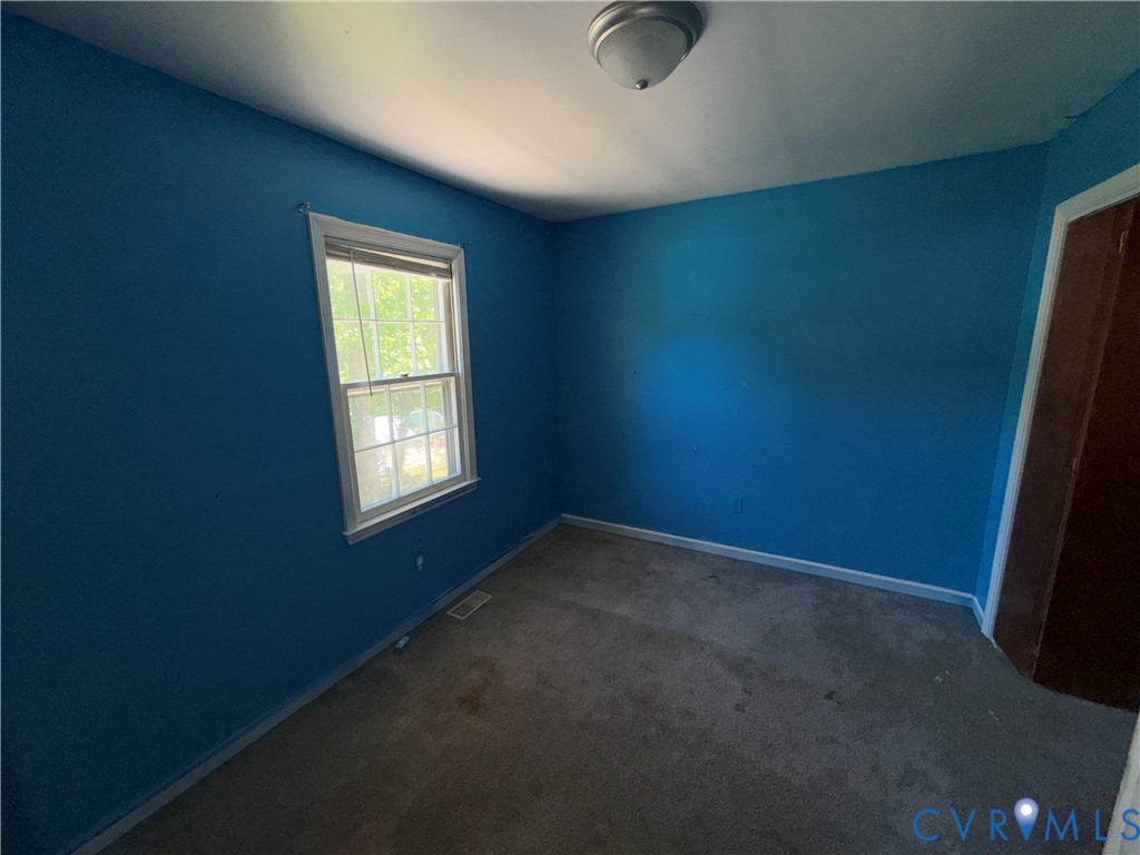 1607 Old Iron Road Hopewell, VA 23860 - Photo 11 of 12 an empty room with a empty space and windows