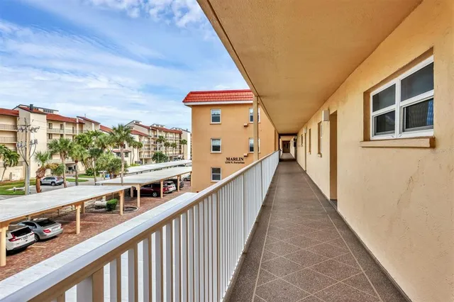 a living room with furniture a lamp and a large window