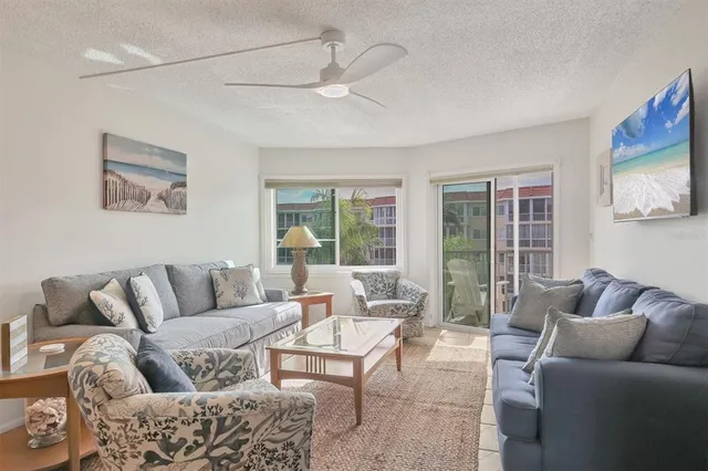 a kitchen with stainless steel appliances granite countertop a stove a sink dishwasher and white cabinets with wooden floor