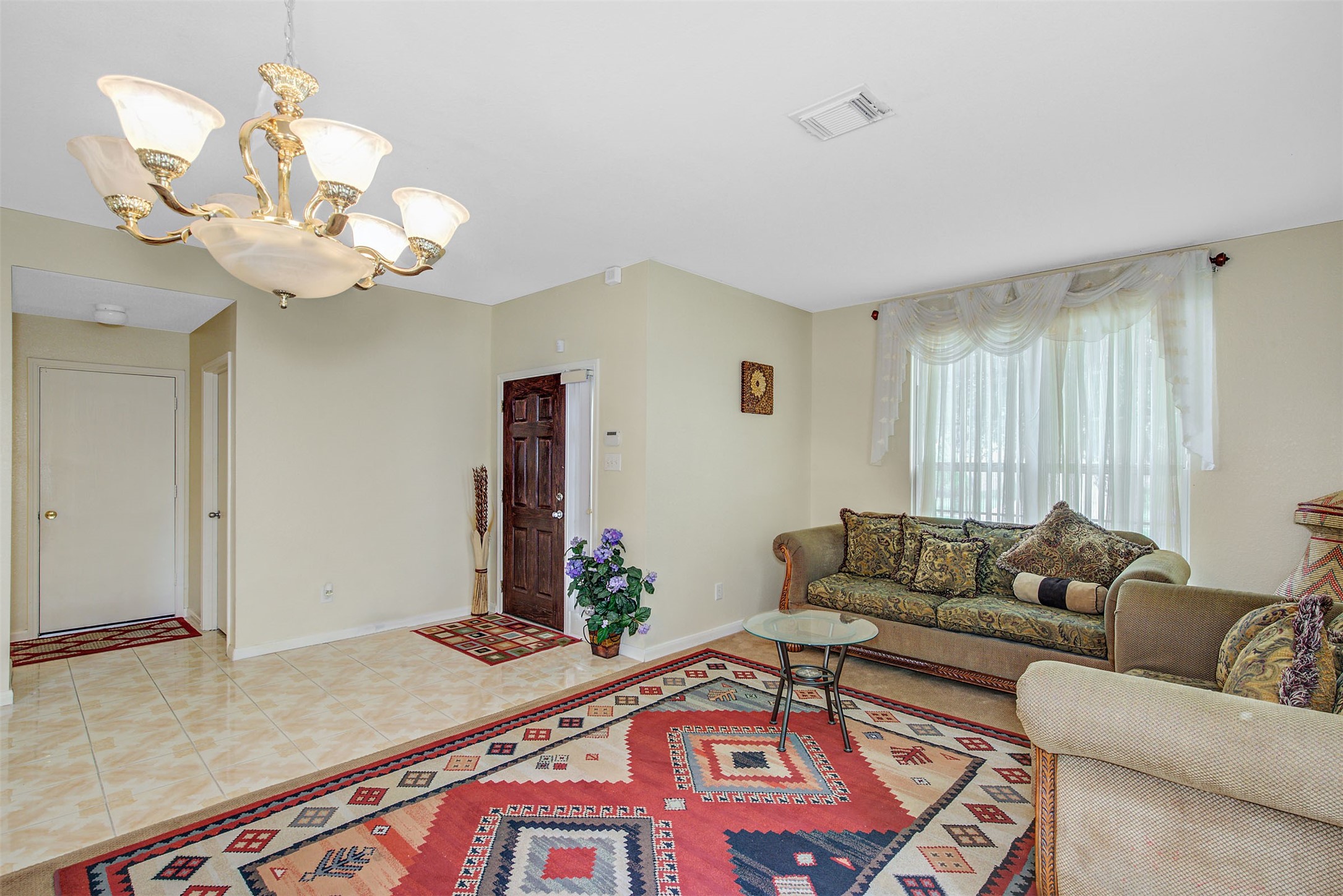 29642 Legends Green Drive Spring, TX 77386 - Photo 11 of 44 a living room with furniture a chandelier and a rug