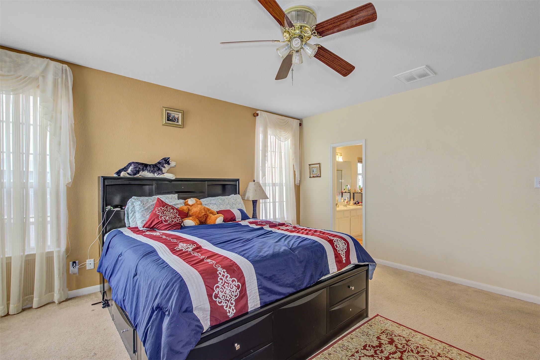 29642 Legends Green Drive Spring, TX 77386 - Photo 20 of 44 a bedroom with a bed and a chandelier