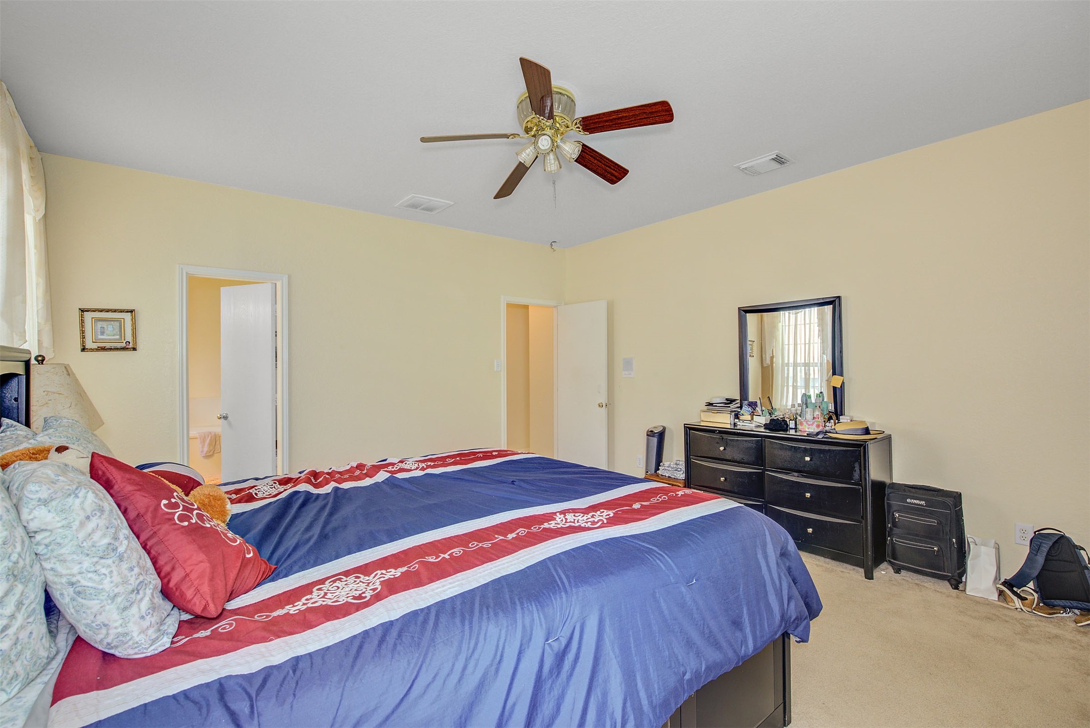 29642 Legends Green Drive Spring, TX 77386 - Photo 21 of 44 a bedroom with a bed and dresser with mirror