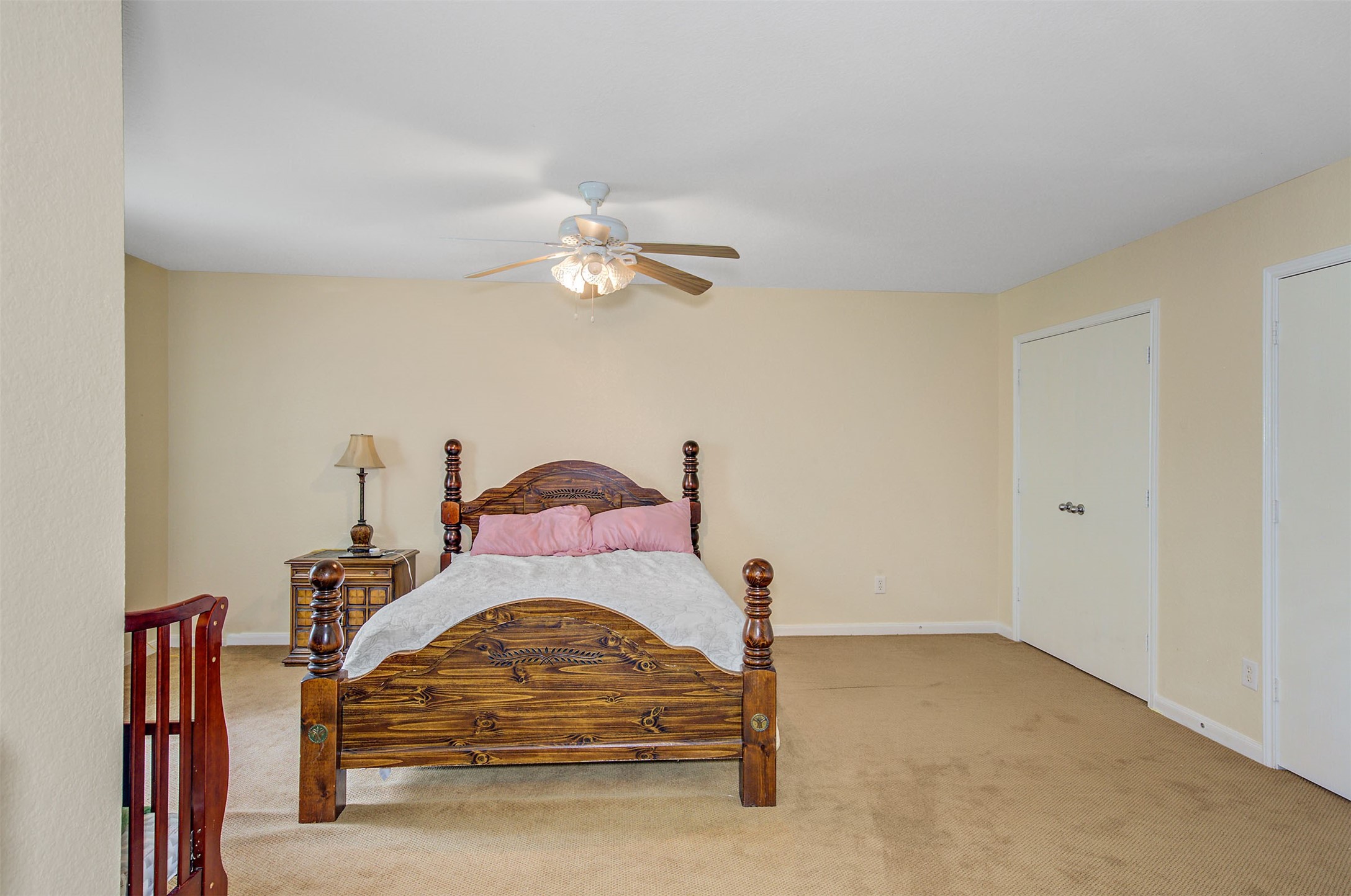 29642 Legends Green Drive Spring, TX 77386 - Photo 34 of 44 a bedroom with a bed and a chandelier