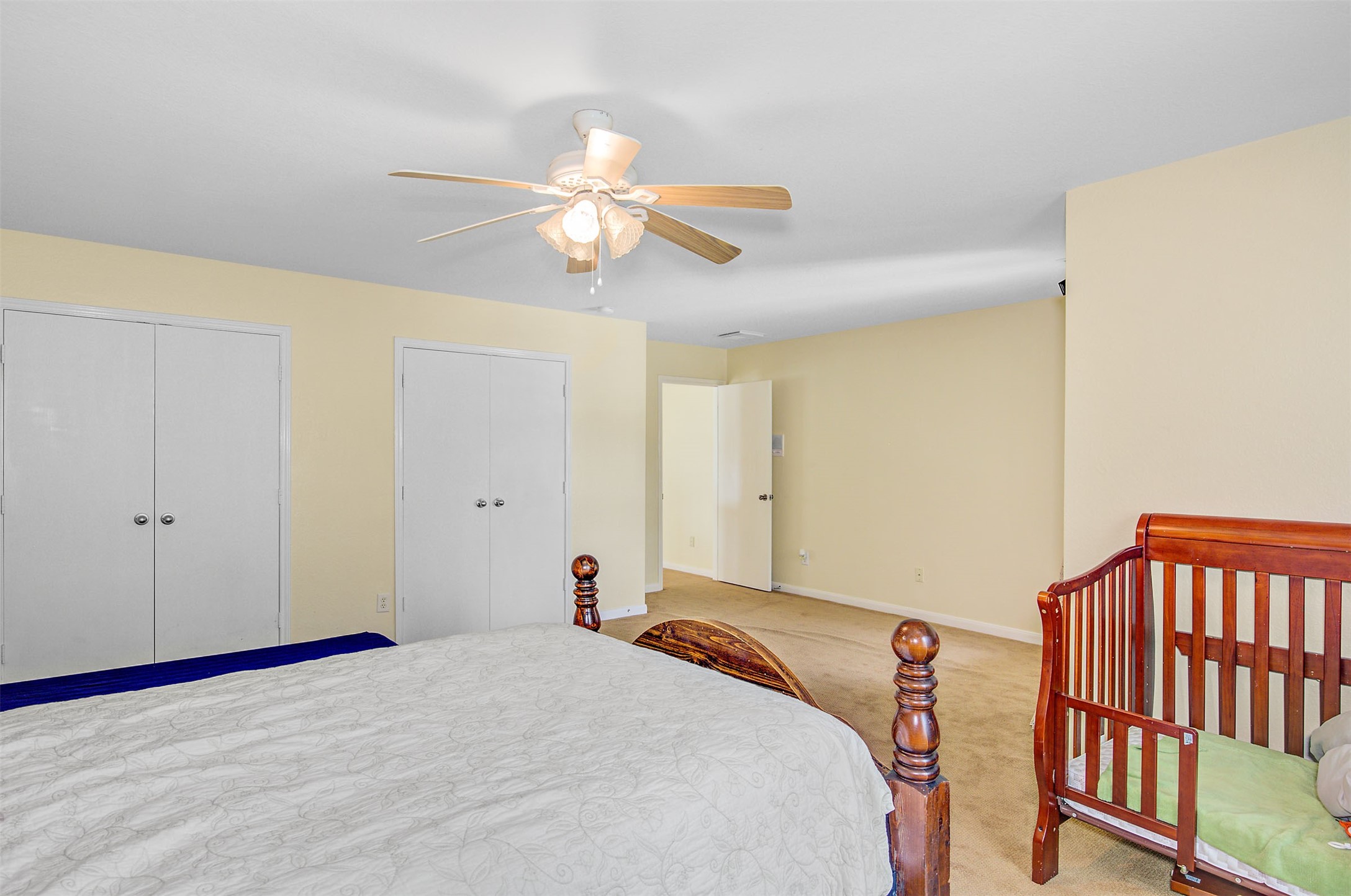 29642 Legends Green Drive Spring, TX 77386 - Photo 35 of 44 a bedroom with a bed and a chandelier