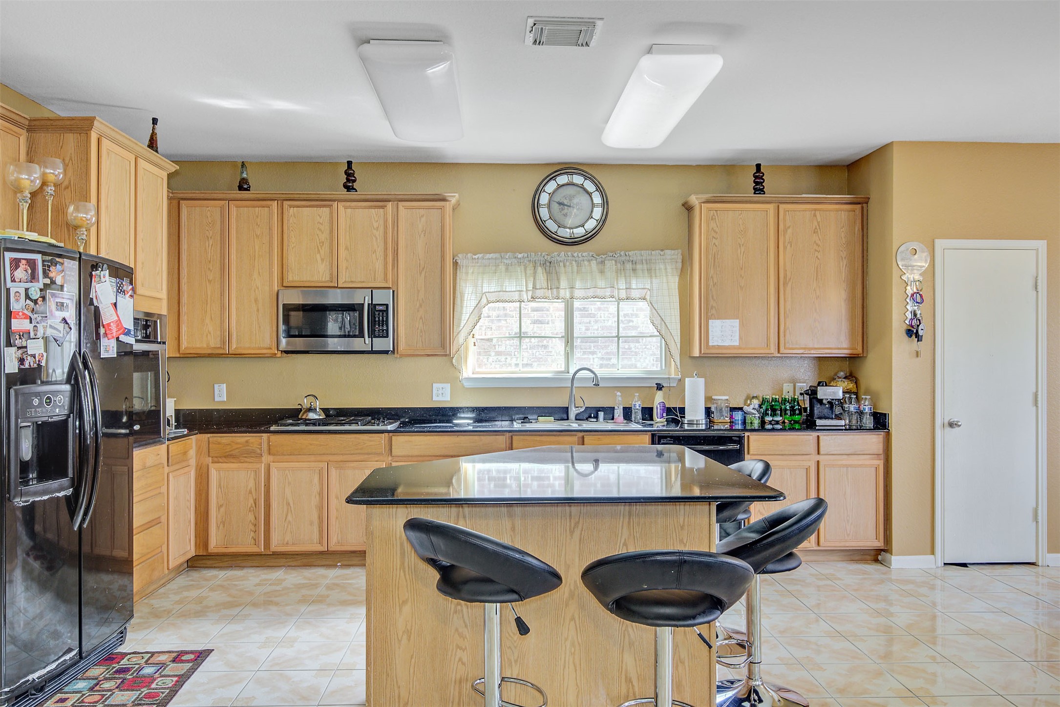 29642 Legends Green Drive Spring, TX 77386 - Photo 7 of 44 a kitchen with stainless steel appliances granite countertop a stove a sink and a refrigerator