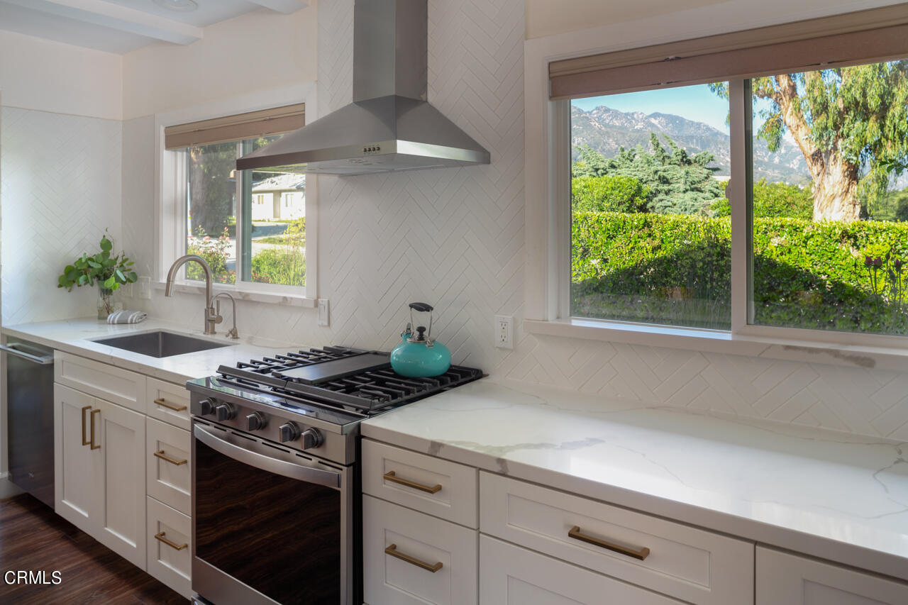 4105 Aralia Road Altadena, CA 91001 - Photo 13 of 41 a kitchen with stainless steel appliances white cabinets and a window