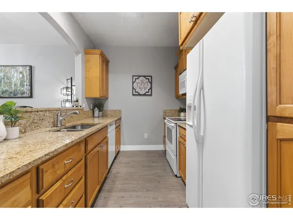 a kitchen with a sink stove and refrigerator