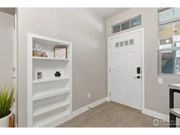 a view of an entryway with wooden floor