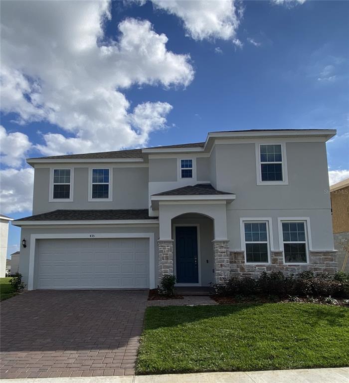 435 Lemongrass Road Minneola, FL 34715 - Photo 1 of 21 a front view of a house with garden