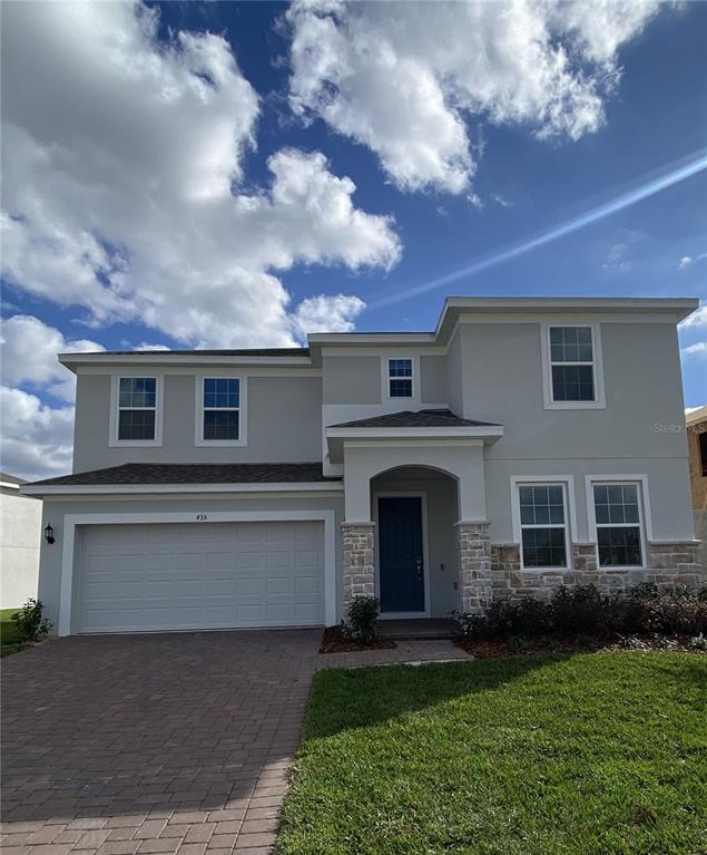 435 Lemongrass Road Minneola, FL 34715 - Photo 2 of 21 a front view of a house with a garden and yard