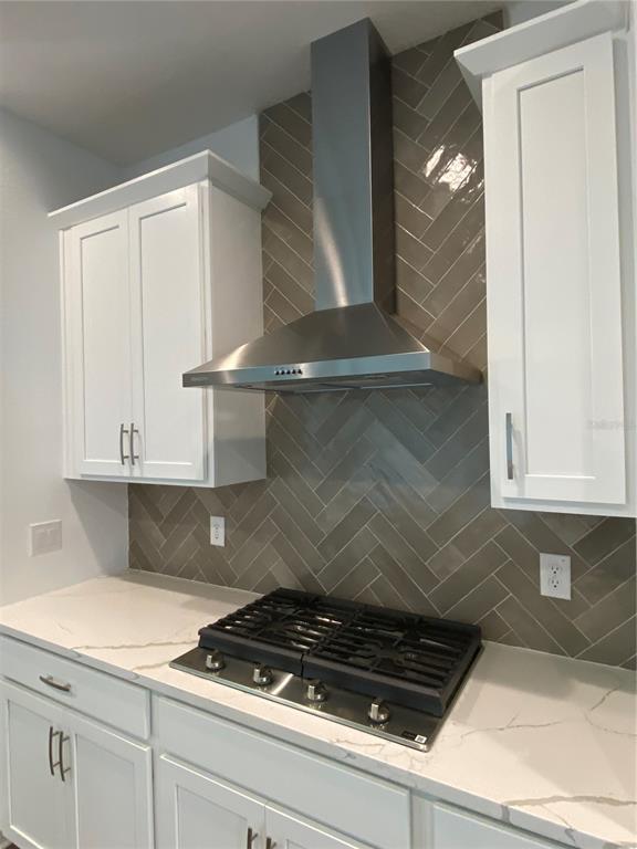 435 Lemongrass Road Minneola, FL 34715 - Photo 4 of 21 a stove top oven sitting inside of a kitchen
