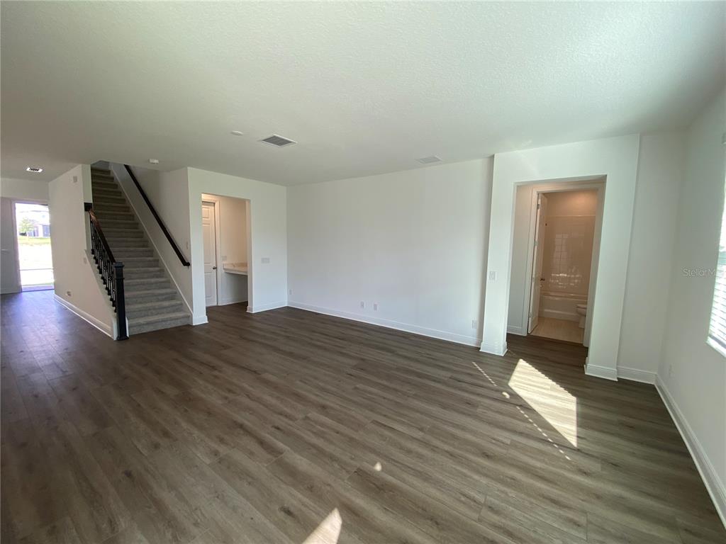 435 Lemongrass Road Minneola, FL 34715 - Photo 7 of 21 wooden floor in an empty room with a window