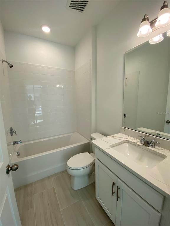 435 Lemongrass Road Minneola, FL 34715 - Photo 8 of 21 a bathroom with a sink a toilet and shower