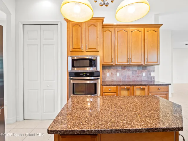 a kitchen with stainless steel appliances granite countertop a sink and cabinets