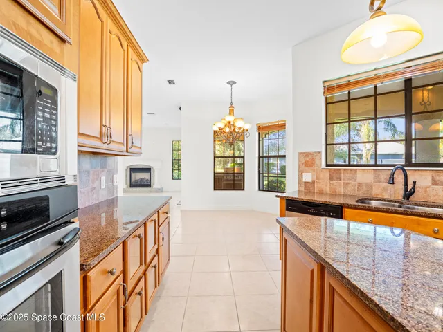 a kitchen with stainless steel appliances granite countertop a sink and dishwasher