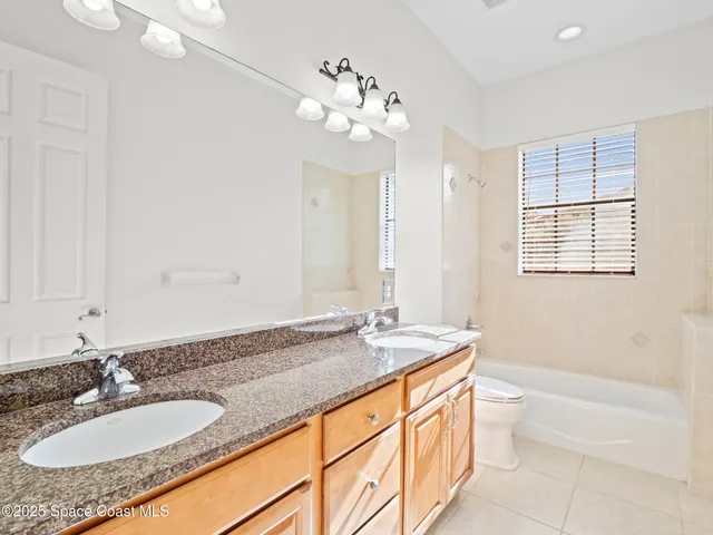 a bathroom with a granite countertop sink a mirror and a vanity
